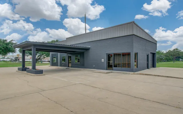 a view of a house with a porch and furniture