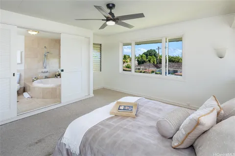 a bedroom with a large bed and a window