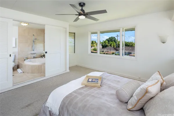 a bedroom with a large bed and a window