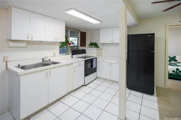 a view of a kitchen with a sink and a refrigerator
