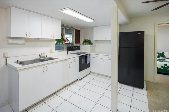 a view of a kitchen with a sink and a refrigerator