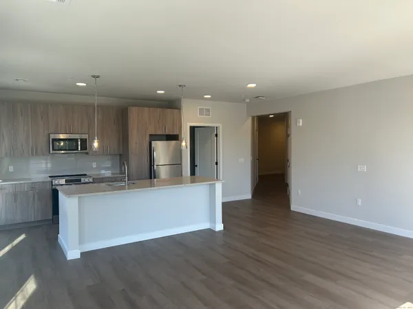 a view of kitchen with stainless steel appliances refrigerator sink and stove