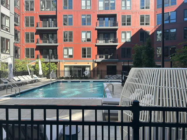 a bathroom with a granite countertop sink a mirror and vanity