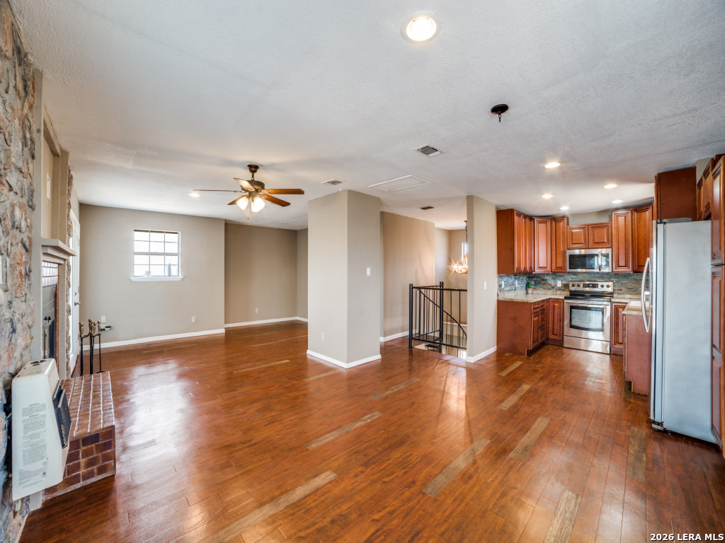 6953 Von Ormy Road Von Ormy, TX 78073 - Photo 11 of 28 a view of kitchen with refrigerator and wooden floor
