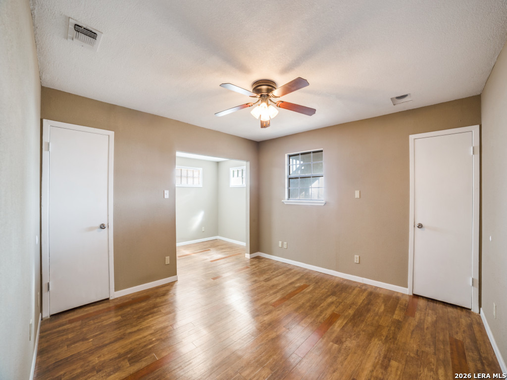 6953 Von Ormy Road Von Ormy, TX 78073 - Photo 16 of 28 a view of an empty room with window and wooden floor