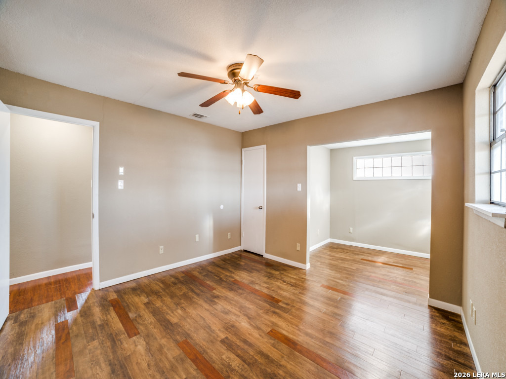 6953 Von Ormy Road Von Ormy, TX 78073 - Photo 17 of 28 a view of an empty room with window and wooden floor