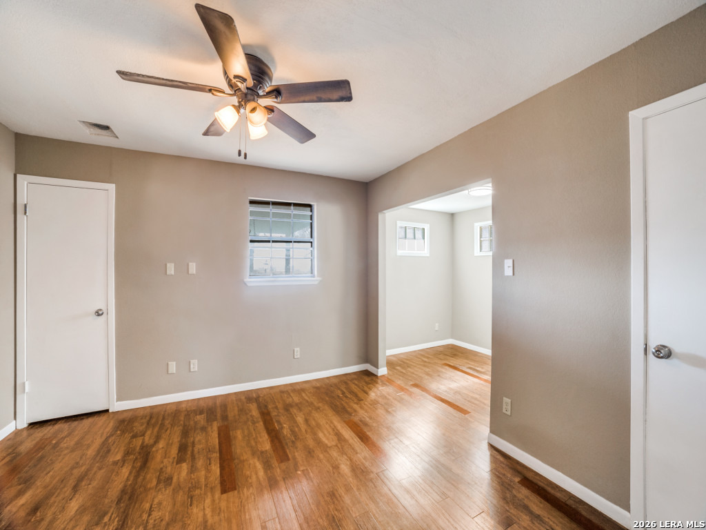 6953 Von Ormy Road Von Ormy, TX 78073 - Photo 18 of 28 a view of an empty room with wooden floor