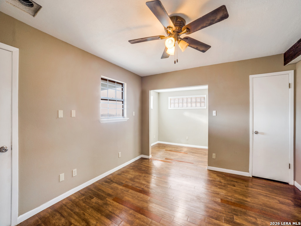 6953 Von Ormy Road Von Ormy, TX 78073 - Photo 19 of 28 a view of an empty room with wooden floor