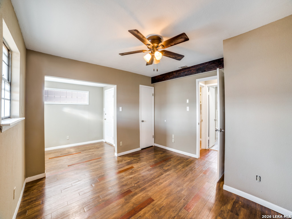 6953 Von Ormy Road Von Ormy, TX 78073 - Photo 20 of 28 a view of an empty room with wooden floor and a window