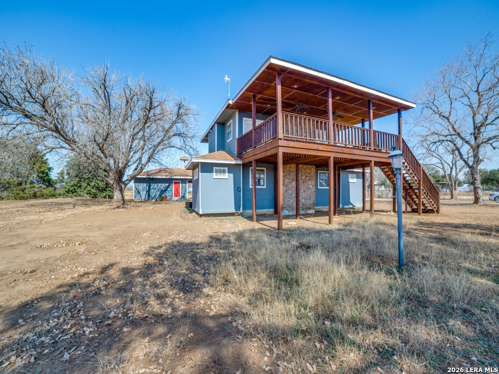6953 Von Ormy Road Von Ormy, TX 78073 - Photo 2 of 28 a front view of a house with a yard