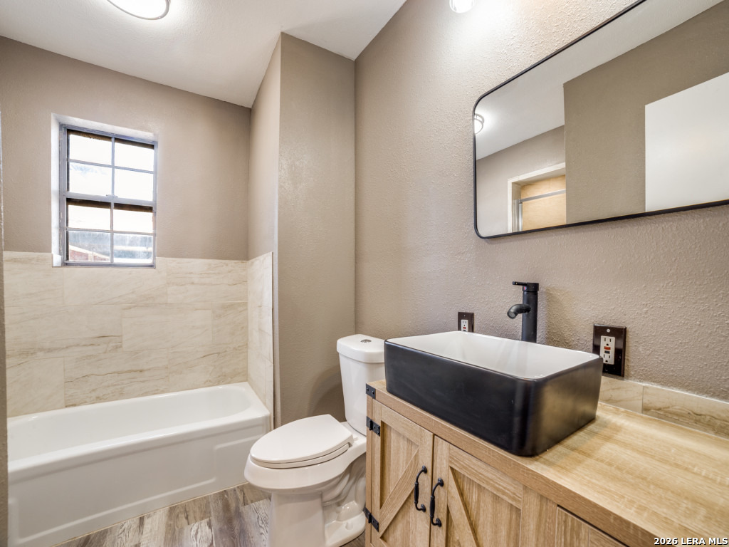 6953 Von Ormy Road Von Ormy, TX 78073 - Photo 21 of 28 a bathroom with a double vanity sink toilet and shower