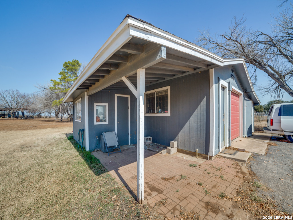 6953 Von Ormy Road Von Ormy, TX 78073 - Photo 22 of 28 a front view of a house with a yard