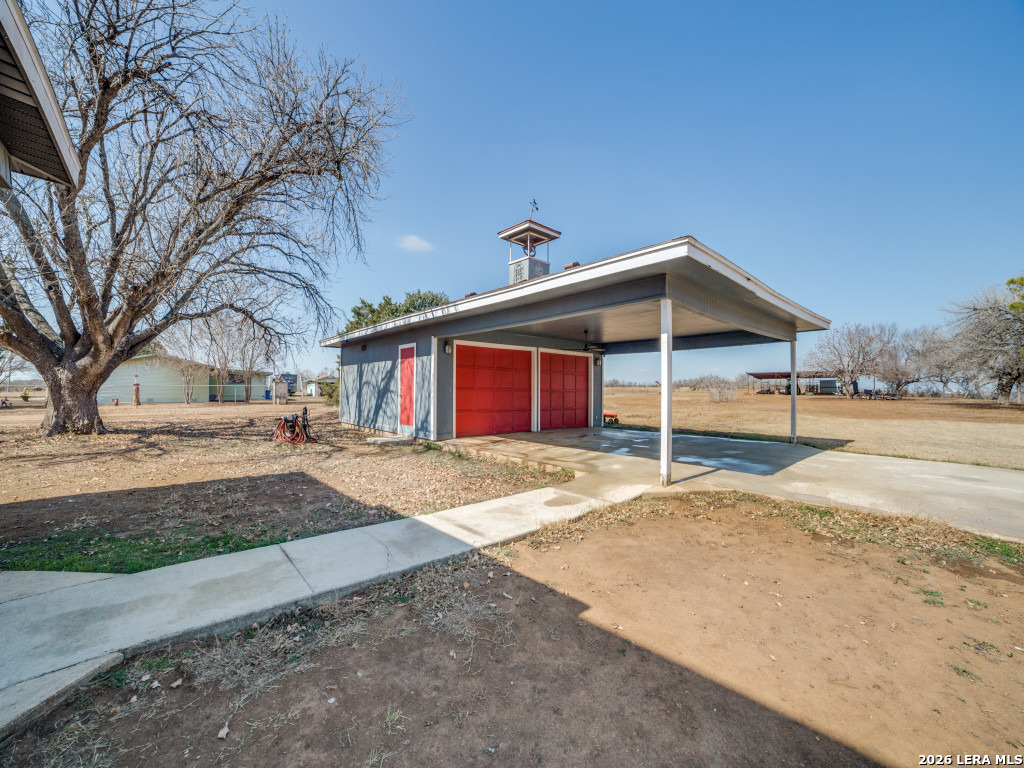 6953 Von Ormy Road Von Ormy, TX 78073 - Photo 23 of 28 a view of a house with a yard and large tree