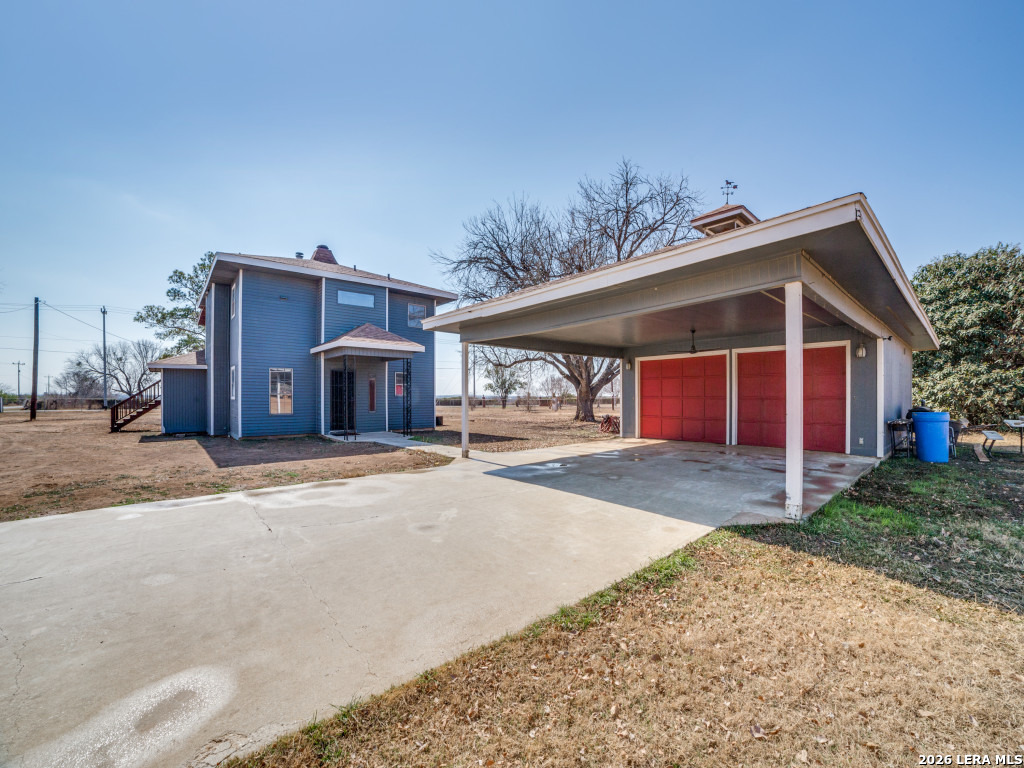 6953 Von Ormy Road Von Ormy, TX 78073 - Photo 5 of 28 a view of a house with a yard and garage