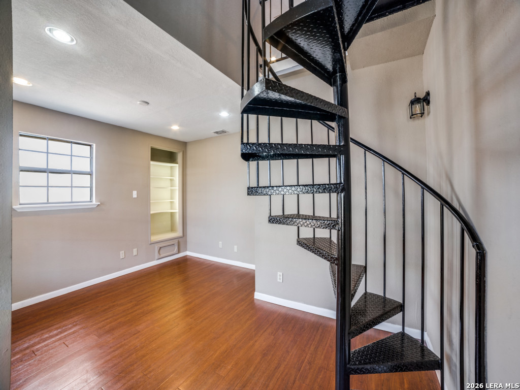 6953 Von Ormy Road Von Ormy, TX 78073 - Photo 6 of 28 a view of an entryway with wooden floor and door