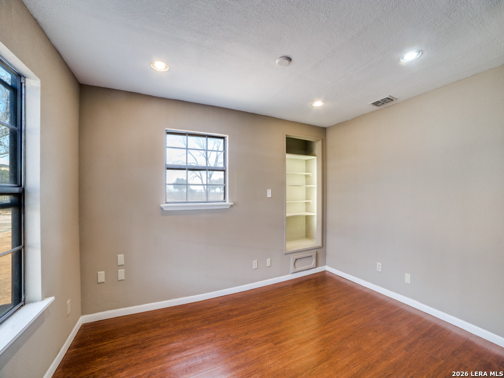 6953 Von Ormy Road Von Ormy, TX 78073 - Photo 8 of 28 a view of empty room with wooden floor and fan