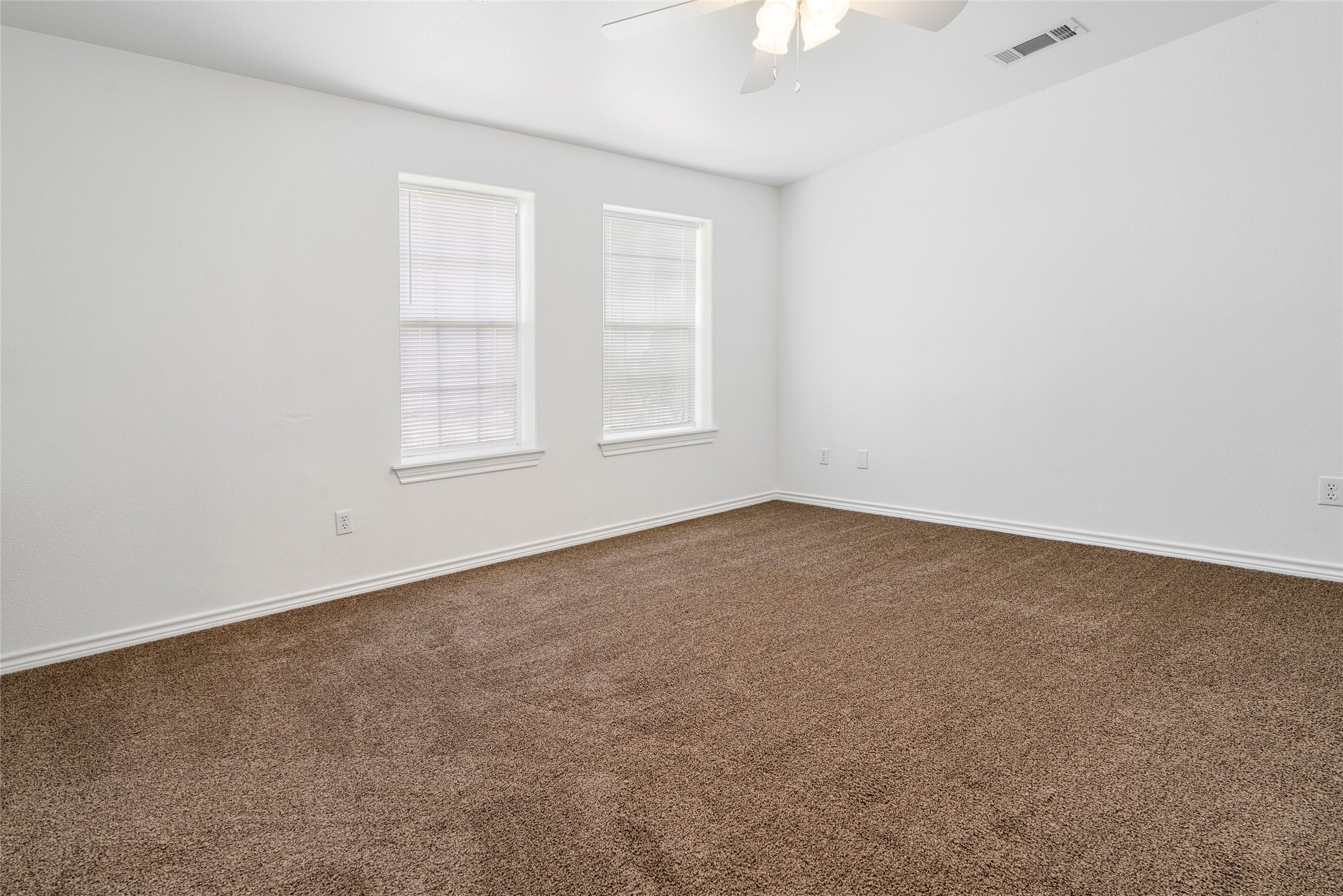 210 Brazos Street, Unit 102 Brazoria, TX 77422 - Photo 12 of 20 an empty room with windows