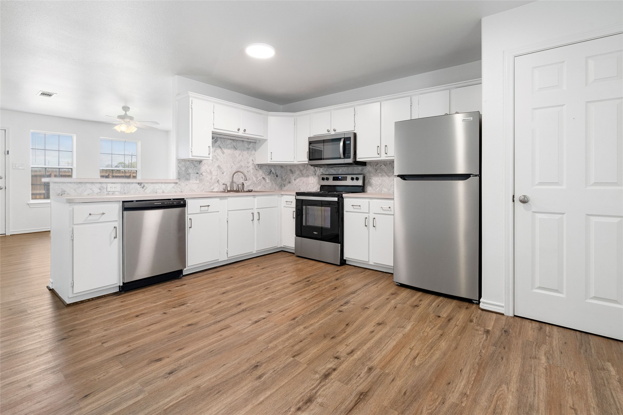 210 Brazos Street, Unit 102 Brazoria, TX 77422 - Photo 2 of 20 a kitchen with stainless steel appliances a refrigerator sink and stove top oven
