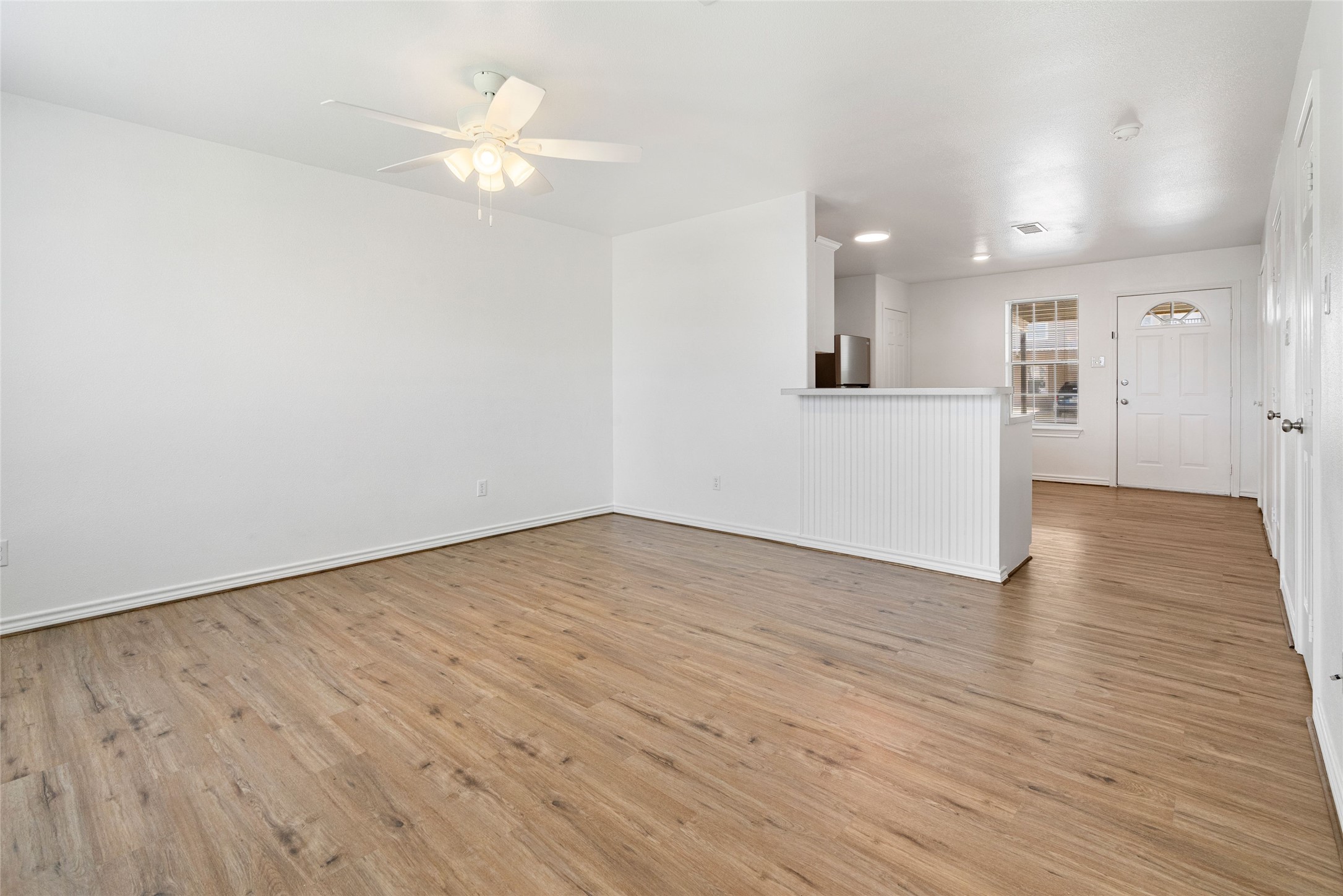 210 Brazos Street, Unit 102 Brazoria, TX 77422 - Photo 9 of 20 a view of a livingroom with a ceiling fan & wooden floor