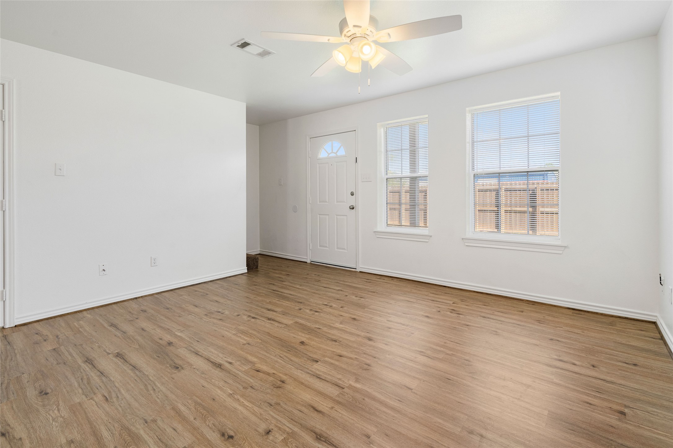 210 Brazos Street, Unit 102 Brazoria, TX 77422 - Photo 10 of 20 a view of an empty room with wooden floor and a window