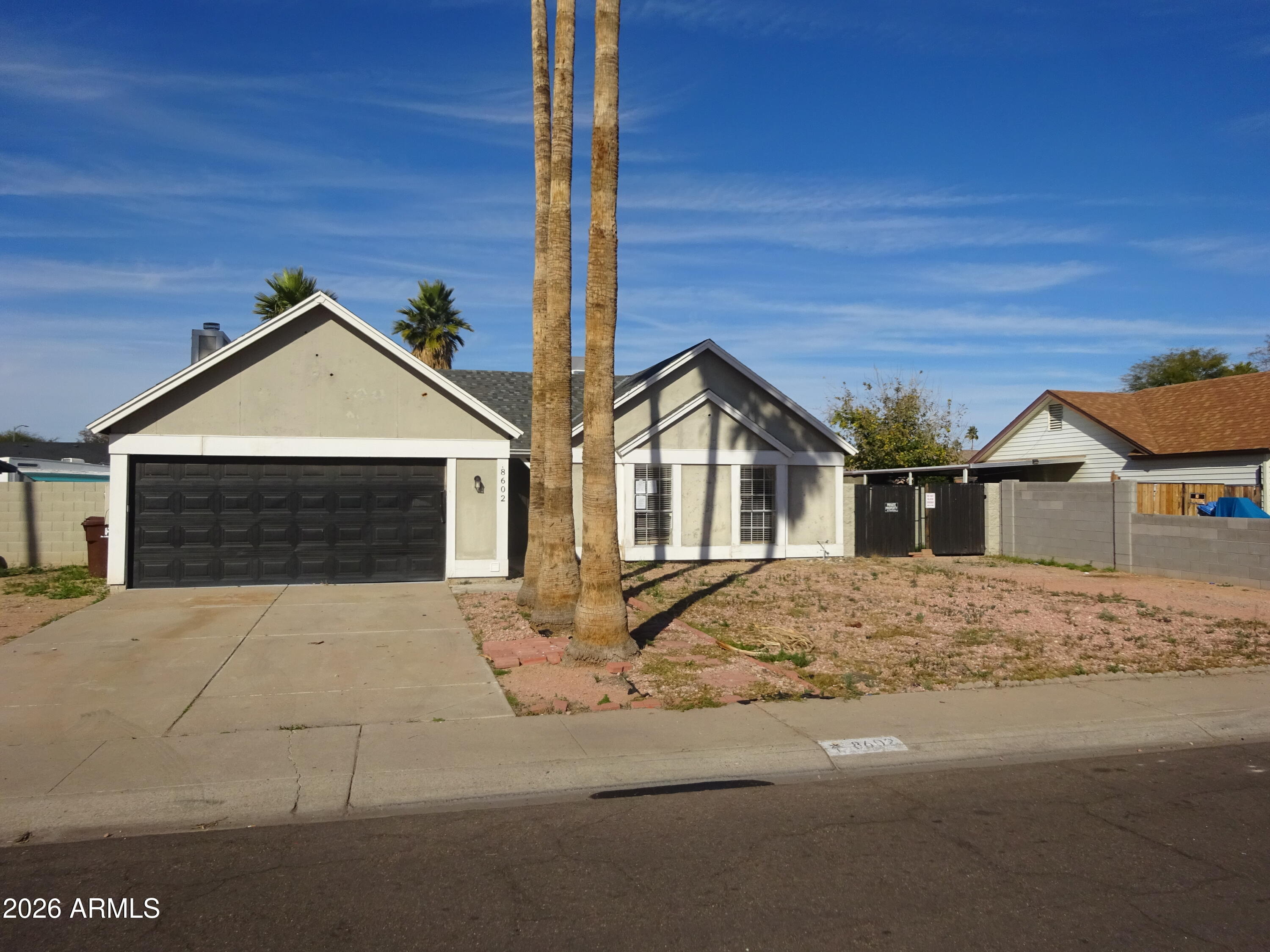 8602 West Wethersfield Road Peoria, AZ 85381 - Photo 1 of 26 a front view of a house with yard