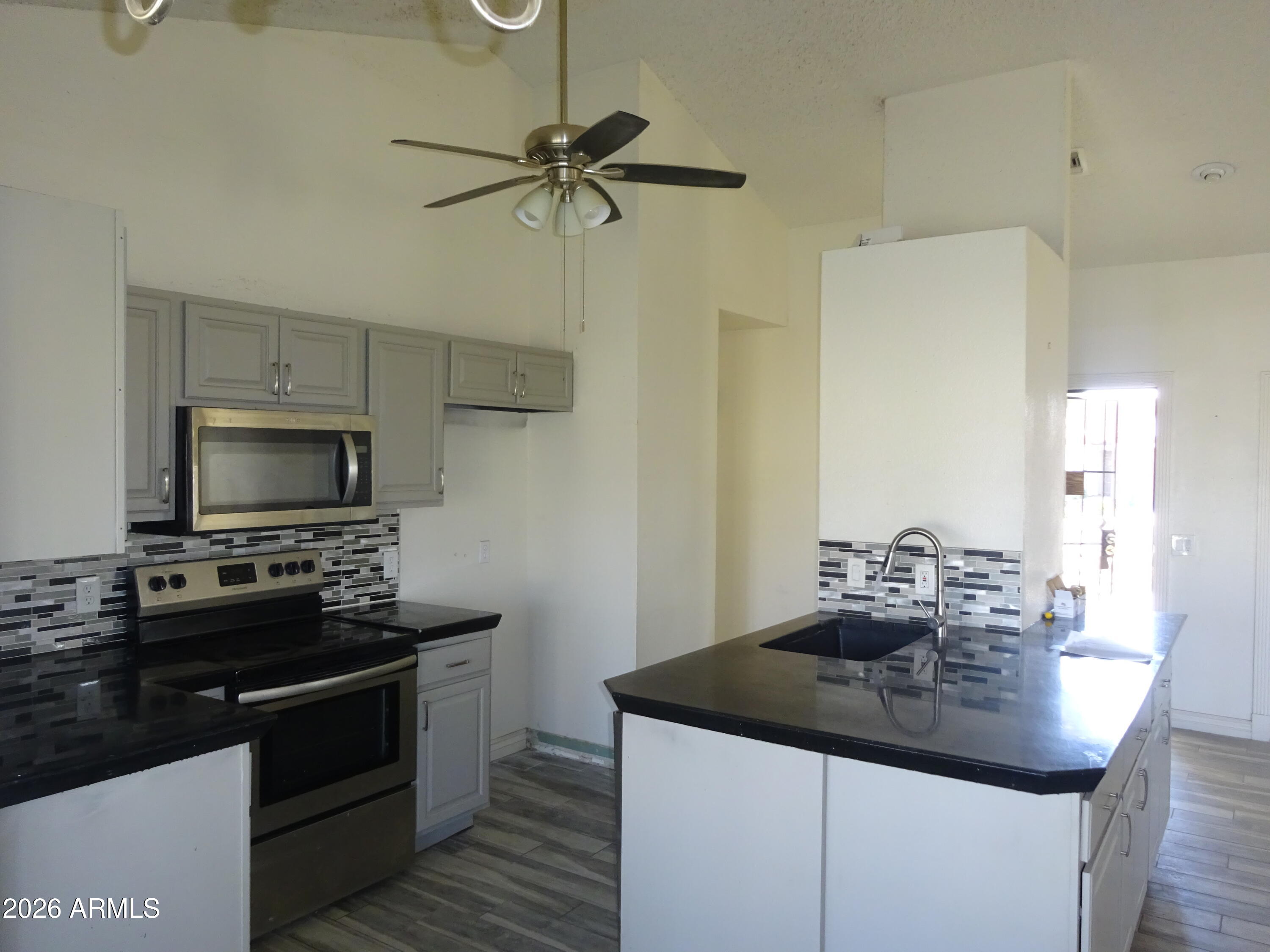 8602 West Wethersfield Road Peoria, AZ 85381 - Photo 13 of 26 a kitchen with a sink appliances and cabinets