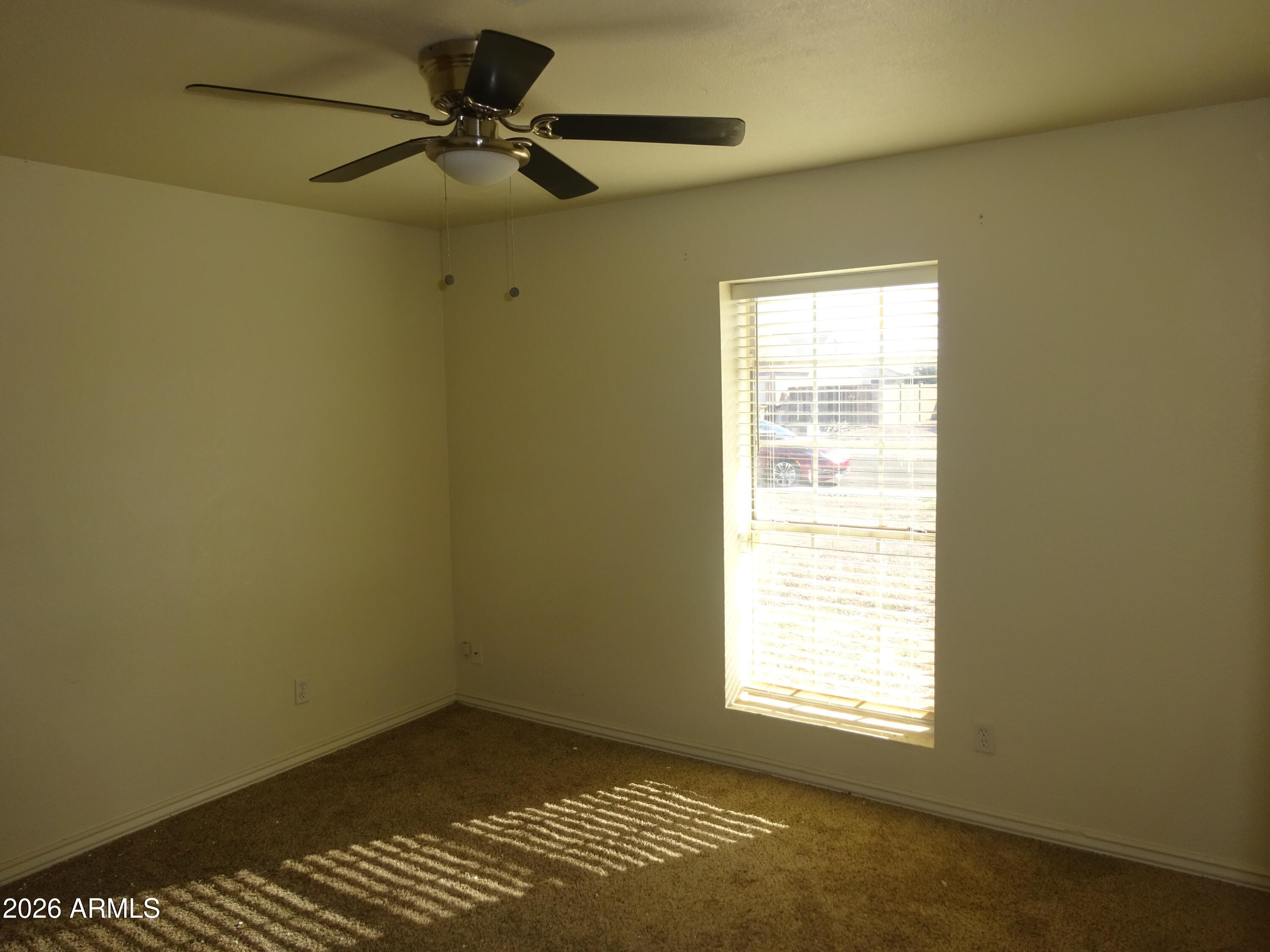 8602 West Wethersfield Road Peoria, AZ 85381 - Photo 17 of 26 a view of an empty room with a window