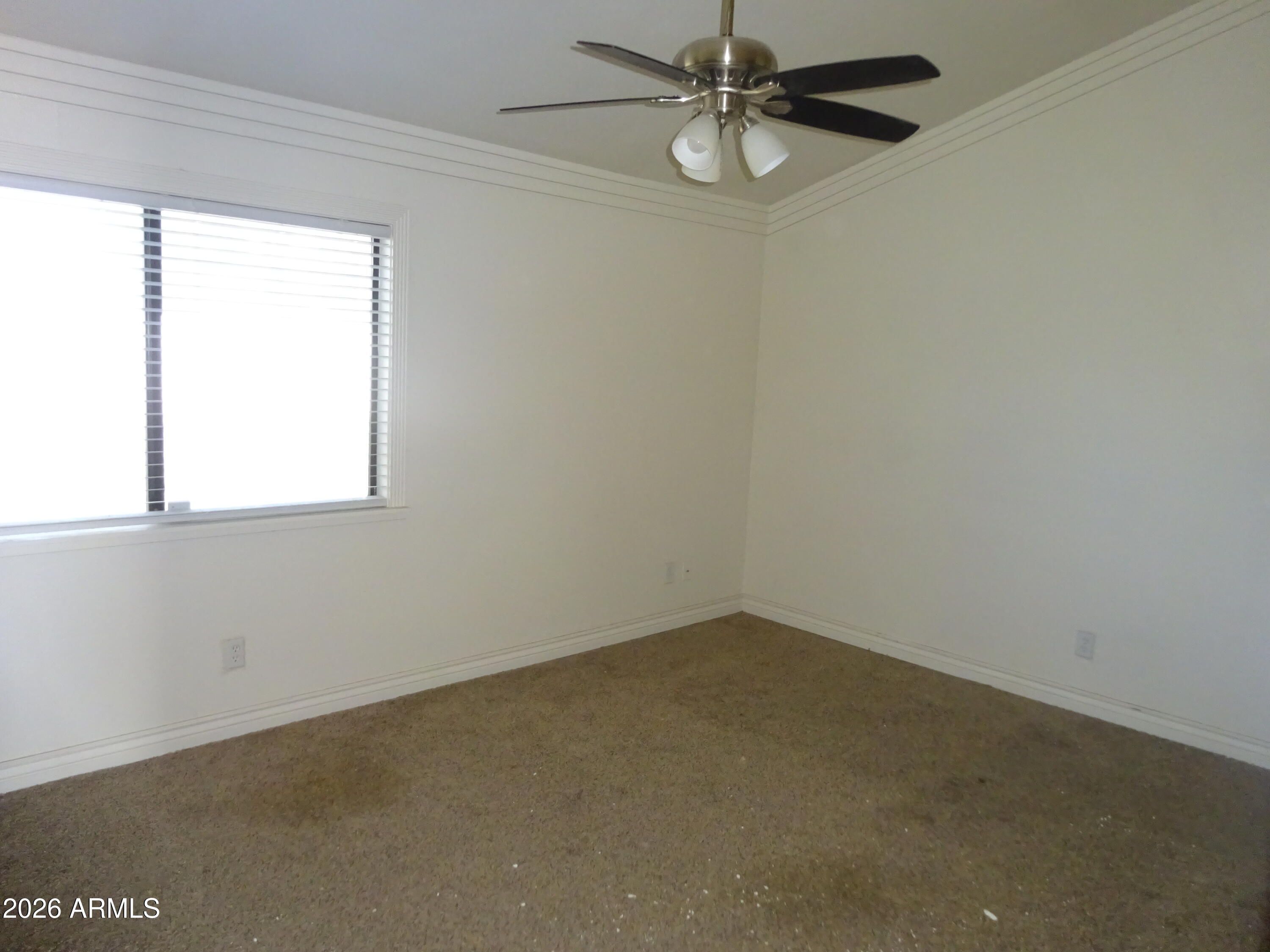 8602 West Wethersfield Road Peoria, AZ 85381 - Photo 19 of 26 an empty room with a window