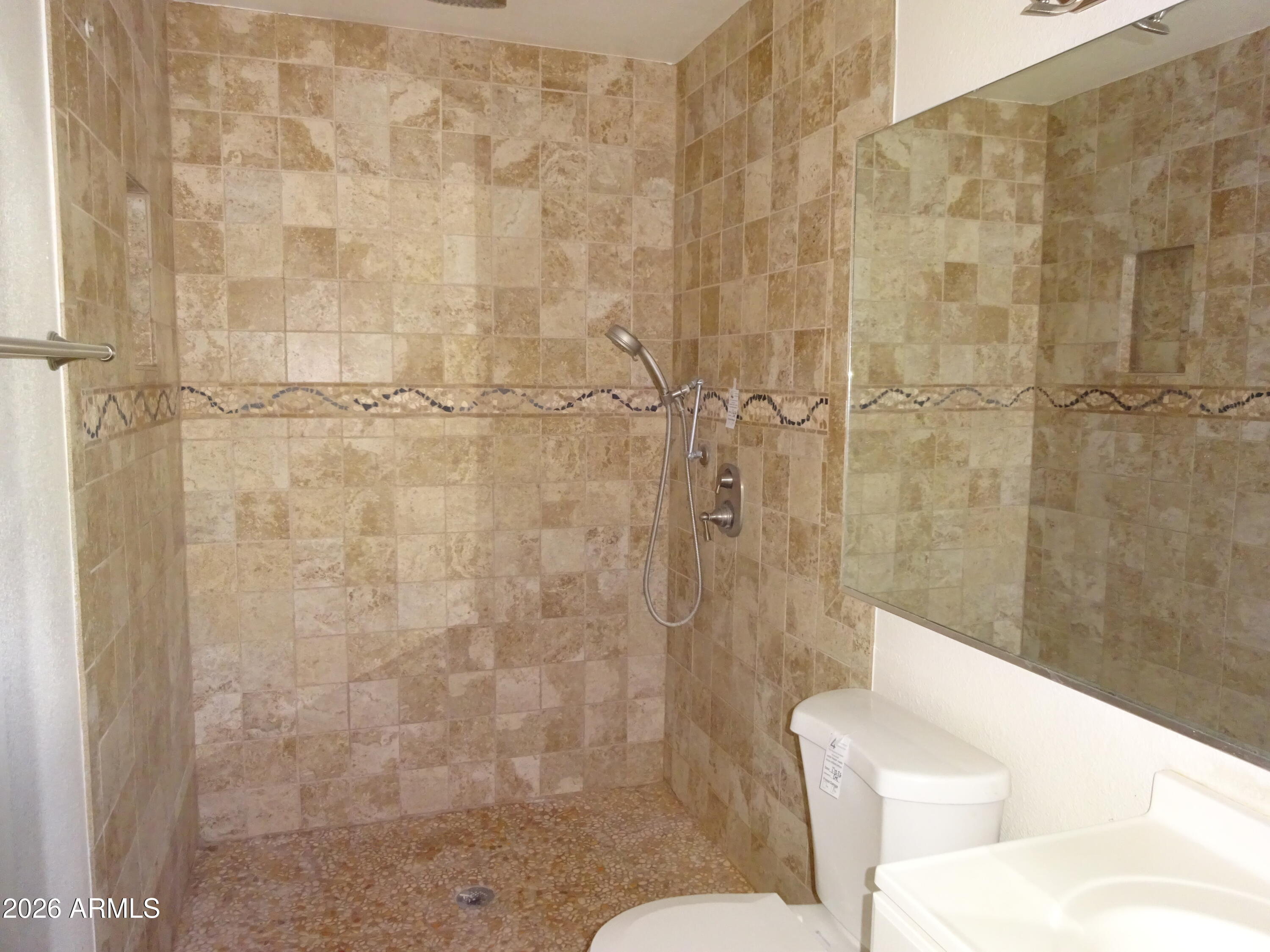 8602 West Wethersfield Road Peoria, AZ 85381 - Photo 20 of 26 a bathroom with a toilet and shower