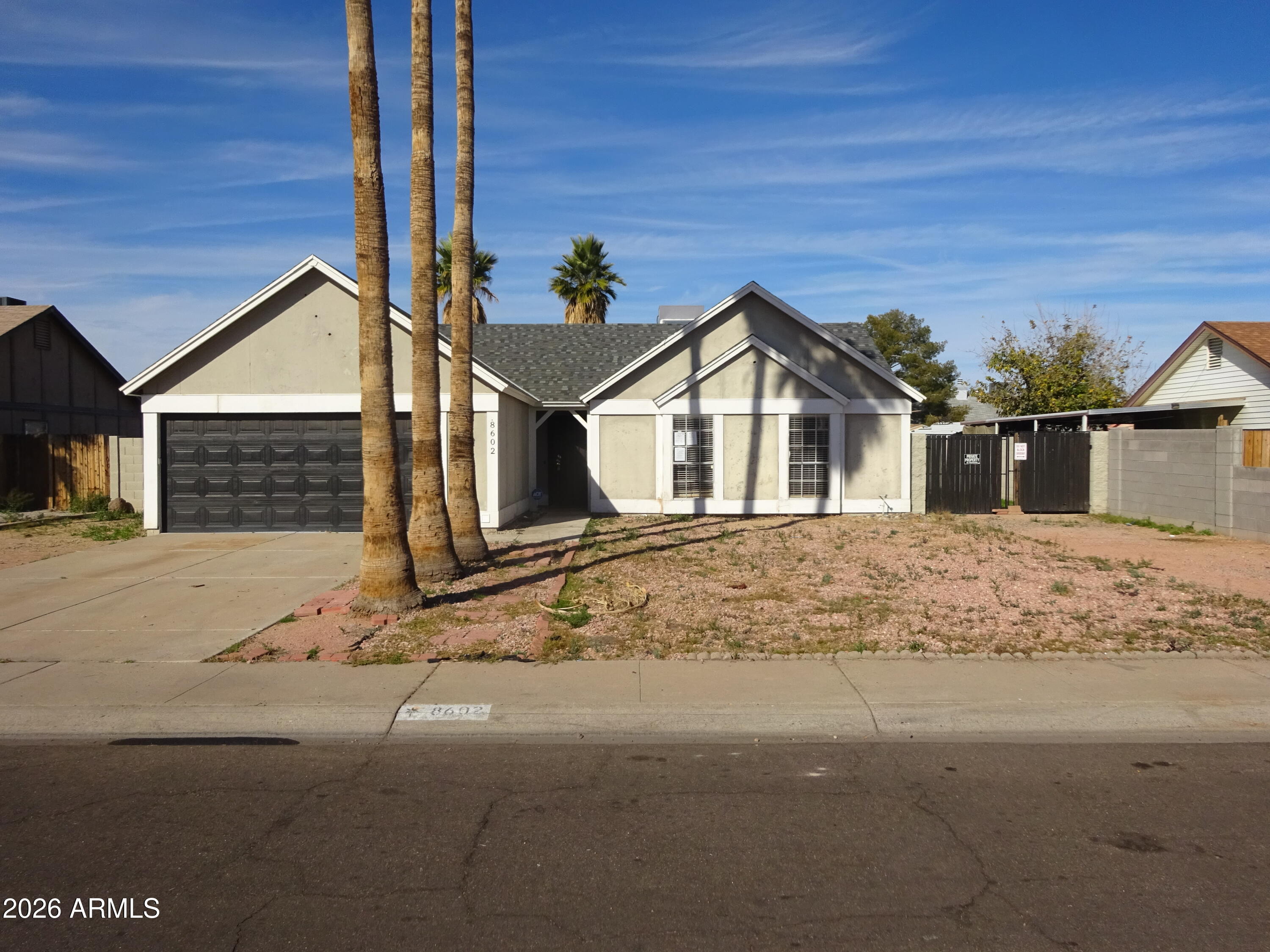 8602 West Wethersfield Road Peoria, AZ 85381 - Photo 2 of 26 a front view of a house with a yard