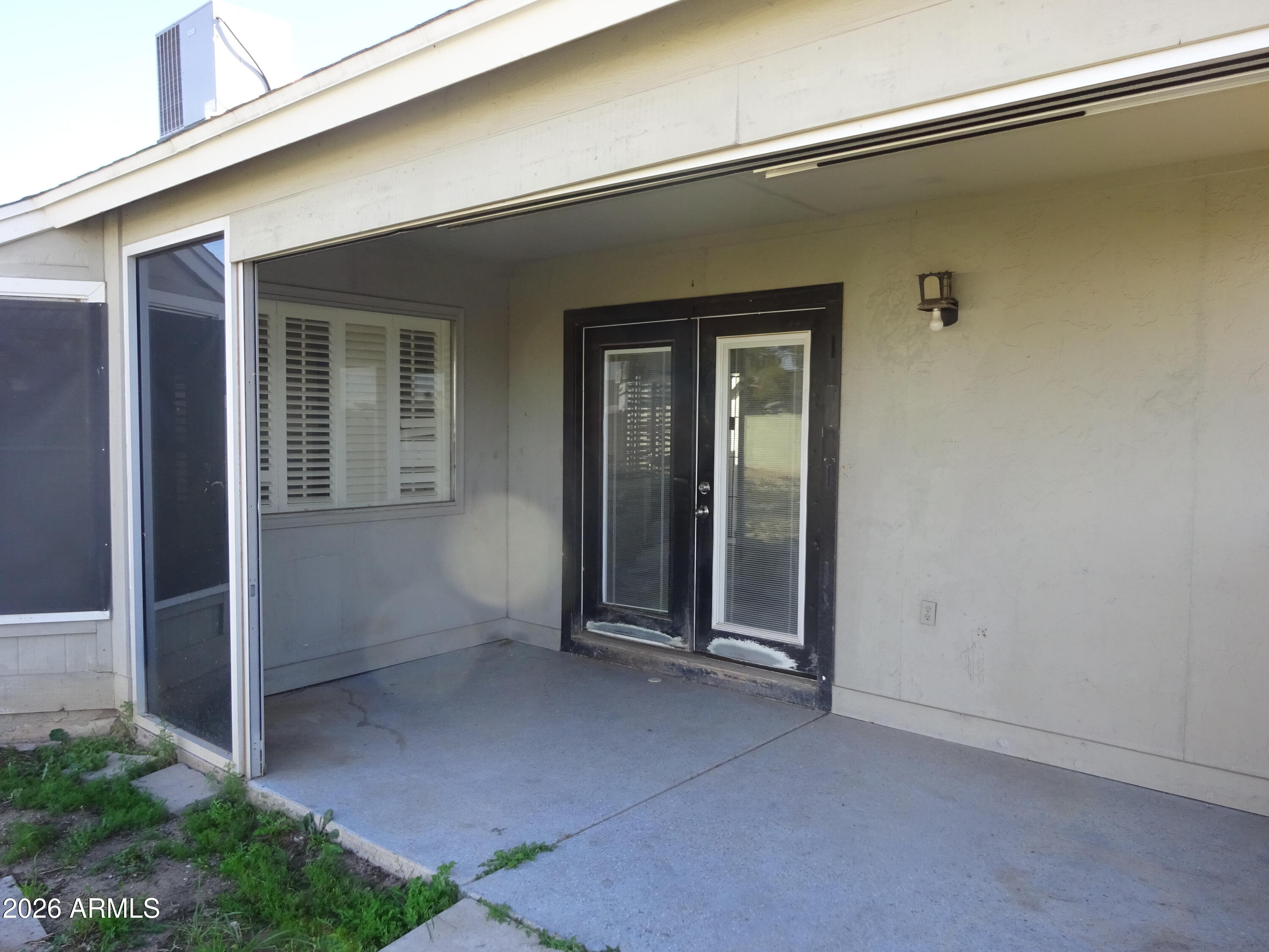 8602 West Wethersfield Road Peoria, AZ 85381 - Photo 21 of 26 front view of a house with a glass door