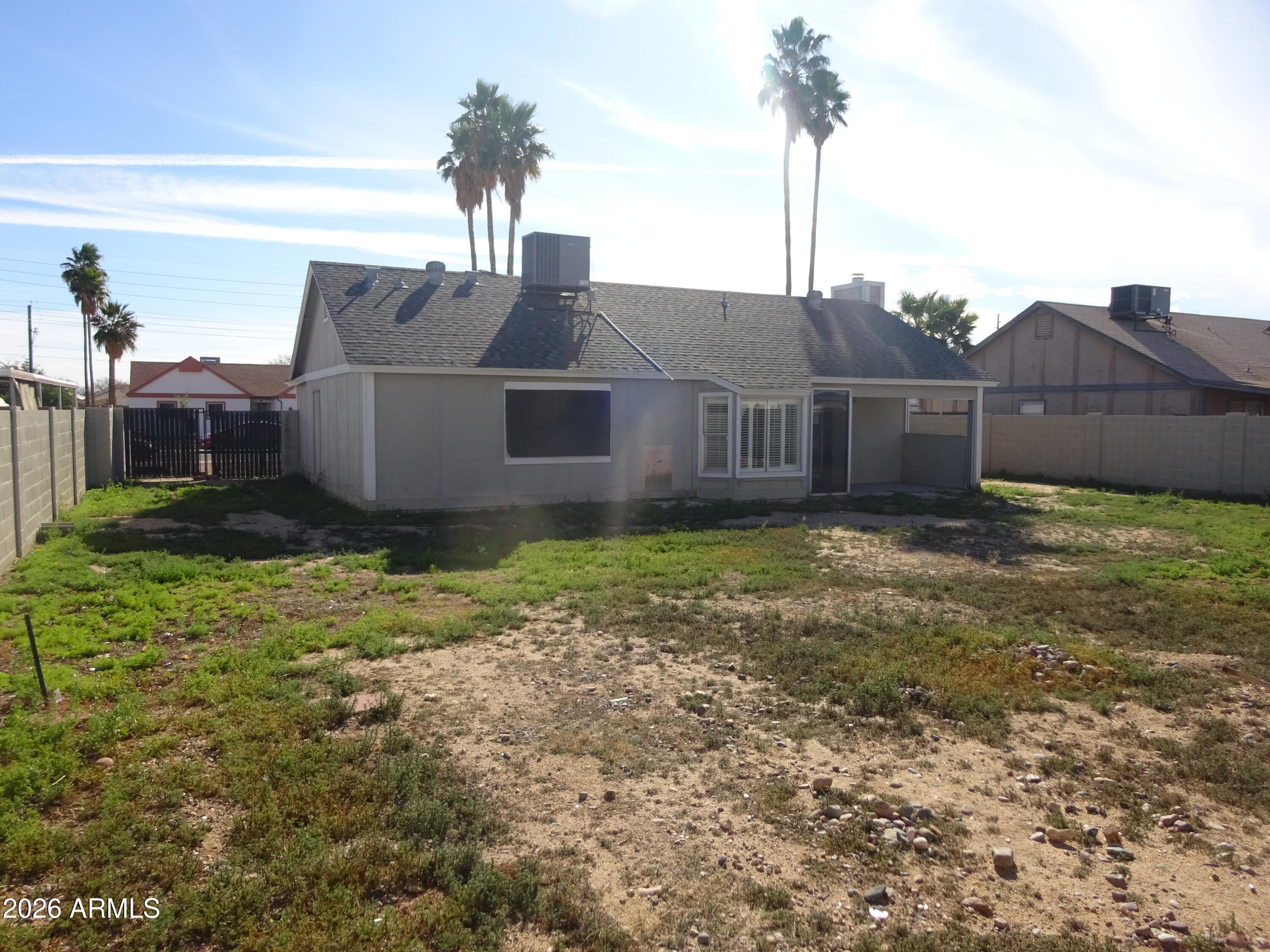 8602 West Wethersfield Road Peoria, AZ 85381 - Photo 25 of 26 a view of a house with a yard and plants