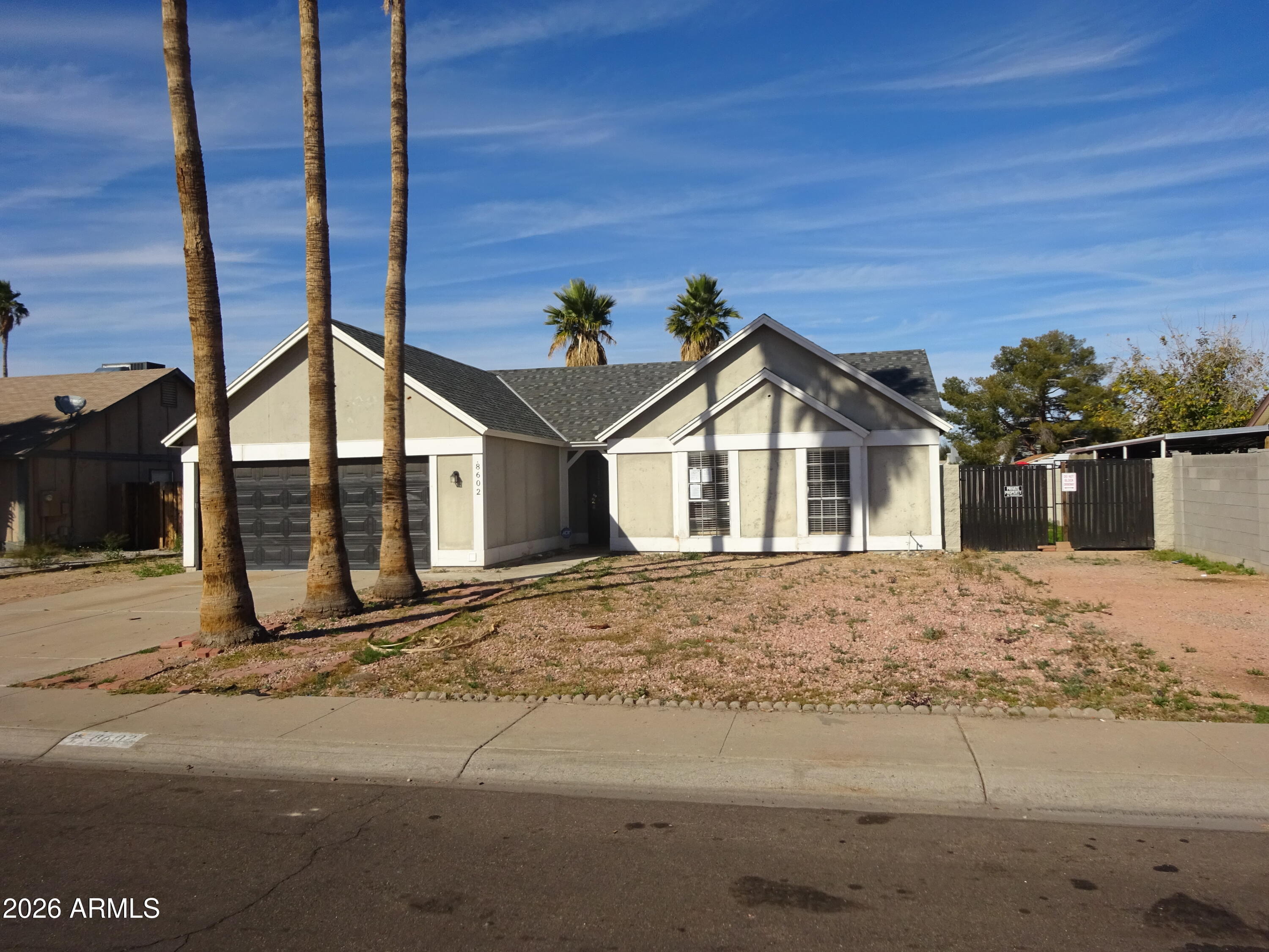 8602 West Wethersfield Road Peoria, AZ 85381 - Photo 4 of 26 a view of a house with wooden fence