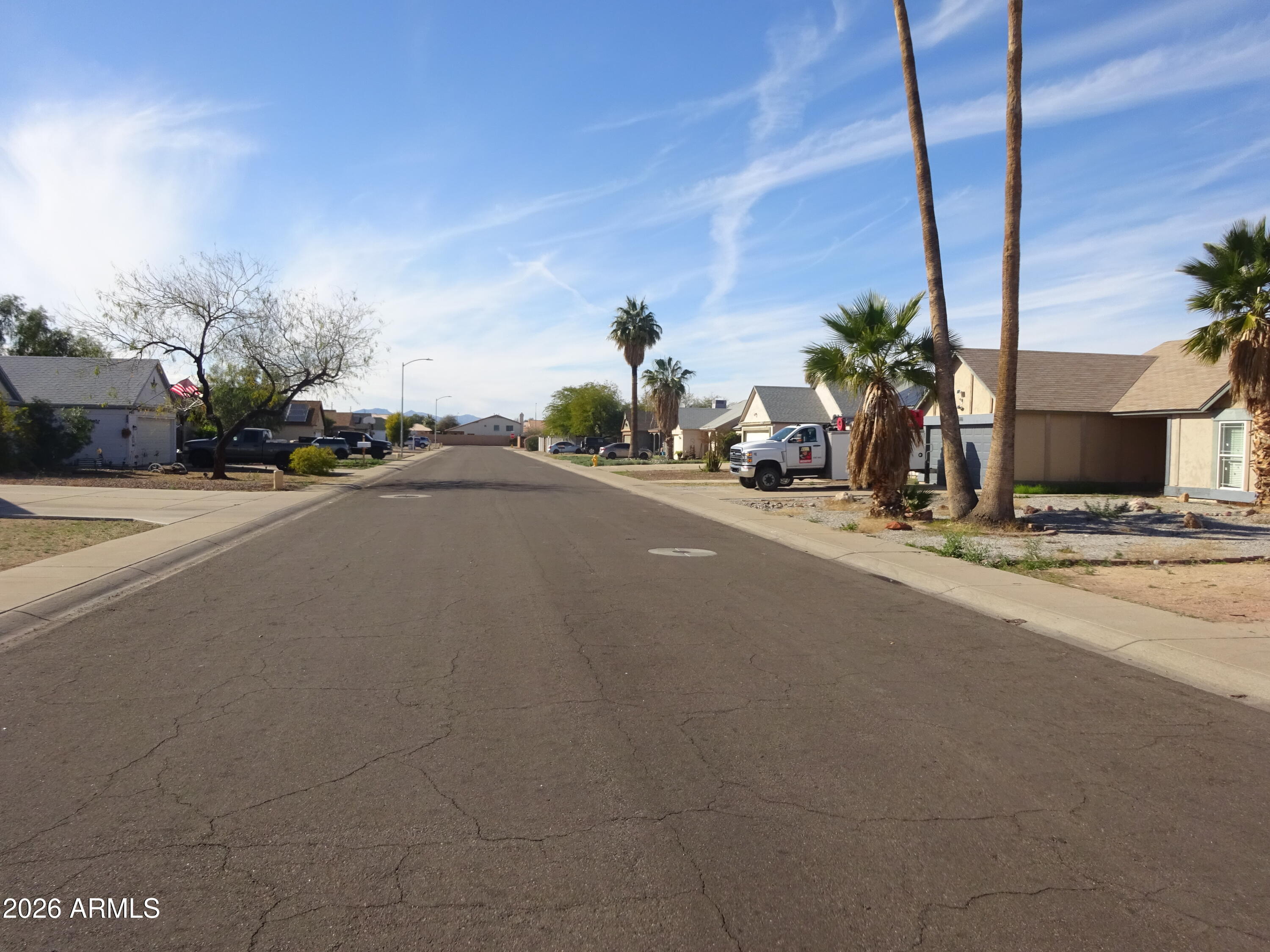 8602 West Wethersfield Road Peoria, AZ 85381 - Photo 7 of 26 a man sitting on a bench in front of a building