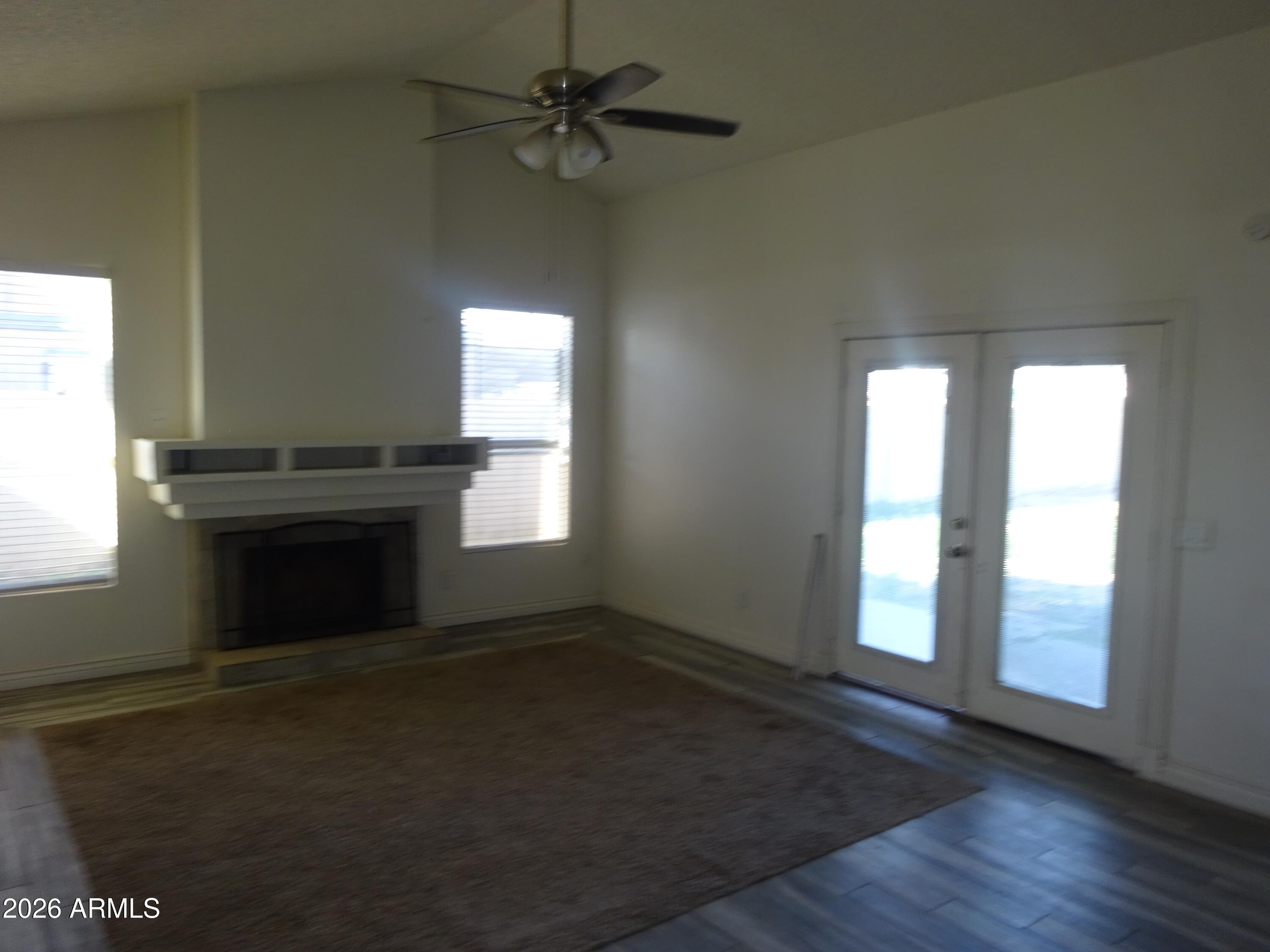 8602 West Wethersfield Road Peoria, AZ 85381 - Photo 8 of 26 an empty room with windows and fireplace