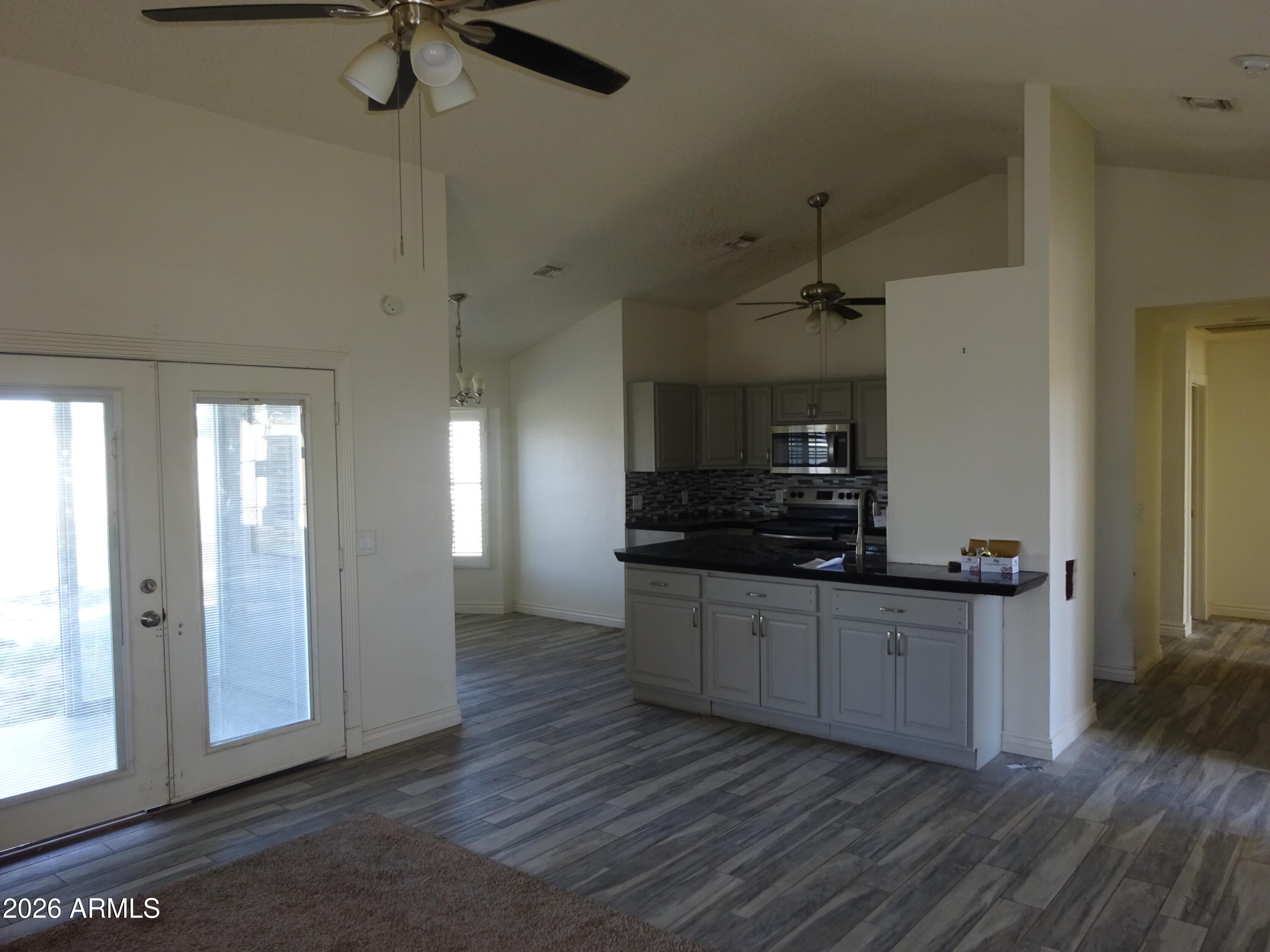 8602 West Wethersfield Road Peoria, AZ 85381 - Photo 9 of 26 a kitchen with stainless steel appliances a sink cabinets and wooden floor