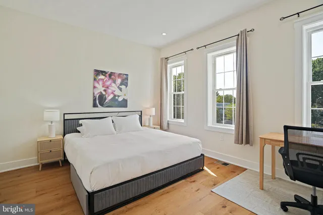 a bedroom with a bed and flat screen tv