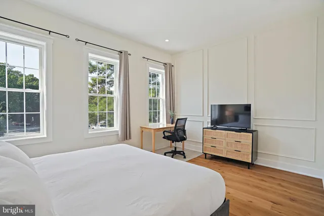 a bedroom with a workspace