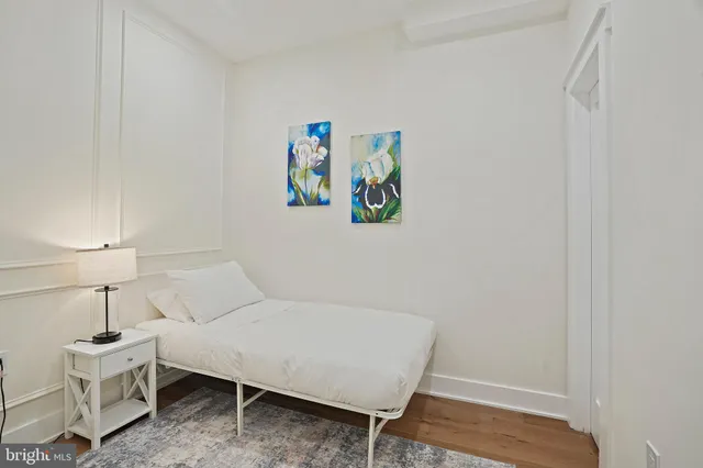 a spacious bedroom with a bed and a rug