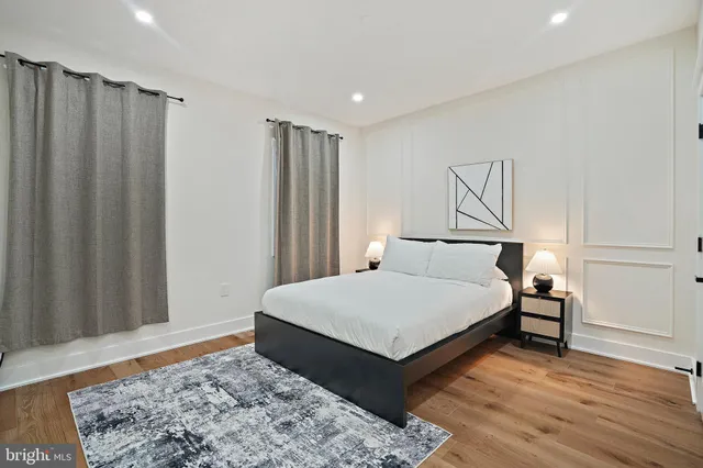 a bedroom with a bed a desk and chair