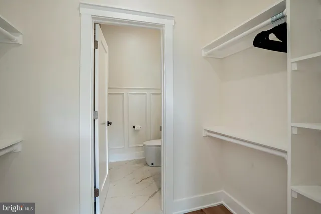 a bedroom with a bed a desk and chair