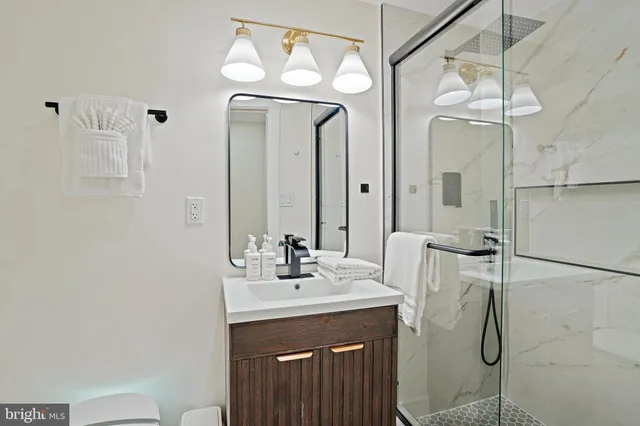 a kitchen with stainless steel appliances a stove a sink a dining table and chairs