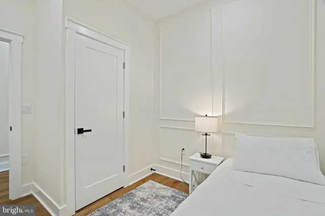 a bathroom with a granite countertop sink a toilet and a mirror