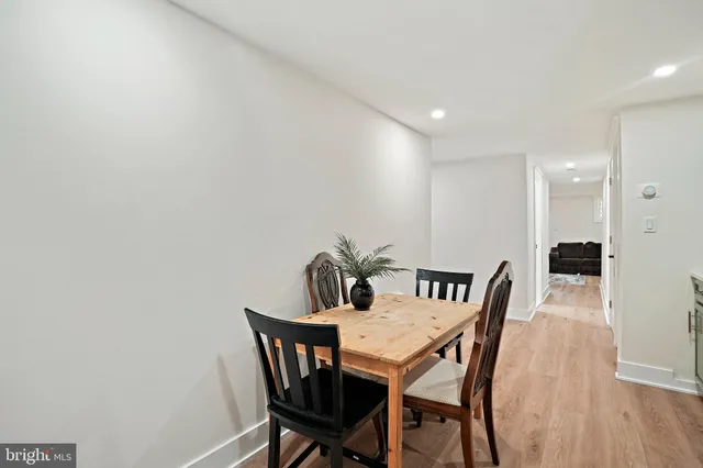 a kitchen with refrigerator and chairs