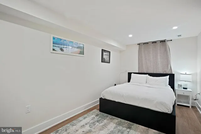 a spacious bedroom with a bed and a shower