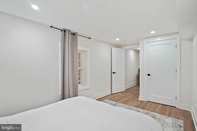 a view of a deck with couches chairs potted plants and wooden floor