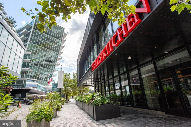 a tall building with large windows and a barbeque