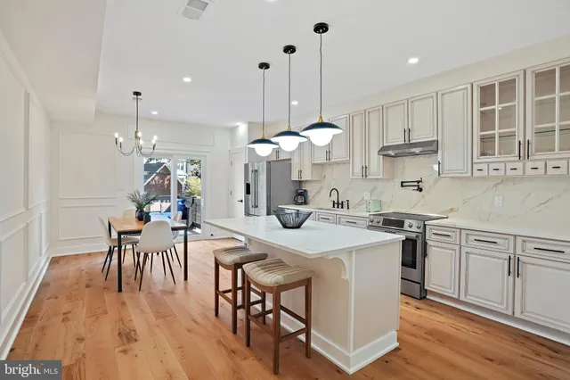 a kitchen with a table a sink and cabinets