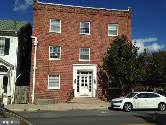 a car parked in front of a brick house