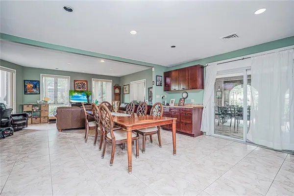 a kitchen with stainless steel appliances kitchen island granite countertop a table and chairs